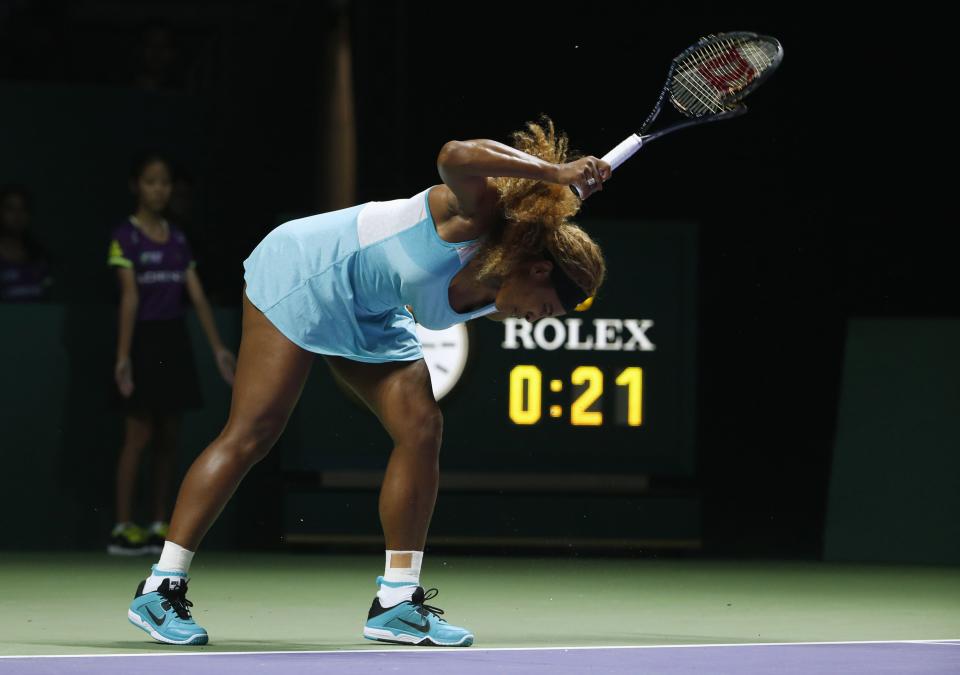 Serena Williams of the U.S. smashes her second racquet during her WTA Finals singles semi-finals tennis match against Caroline Wozniacki of Denmark at the Singapore Indoor Stadium