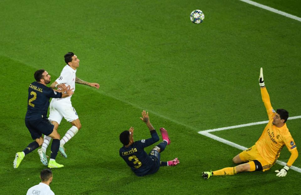 Real Madrid's Spanish defender Dani Carvajal (L), Paris Saint-Germain's Argentine midfielder Angel Di Maria (2nd L), Paris Saint-Germain's French defender Presnel Kimpembe (C) and Real Madrid's Belgian goalkeeper Thibaut Courtois (R) eye the ball during the UEFA Champions league Group A football match between Paris Saint-Germain and Real Madrid, at the Parc des Princes stadium, in Paris, on September 18, 2019. (Photo by CHRISTOPHE ARCHAMBAULT / AFP)        (Photo credit should read CHRISTOPHE ARCHAMBAULT/AFP/Getty Images)