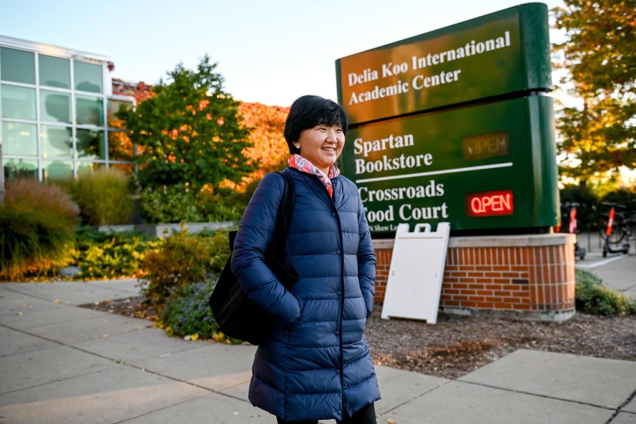 Aliya Bizhanova, a Michigan State University Ph.D. student, leaves the Delia Kool International Academic Center on Wednesday, Nov. 3, 2021, on the MSU campus in East Lansing. Bizhanova is an international student from Kazakhstan.
