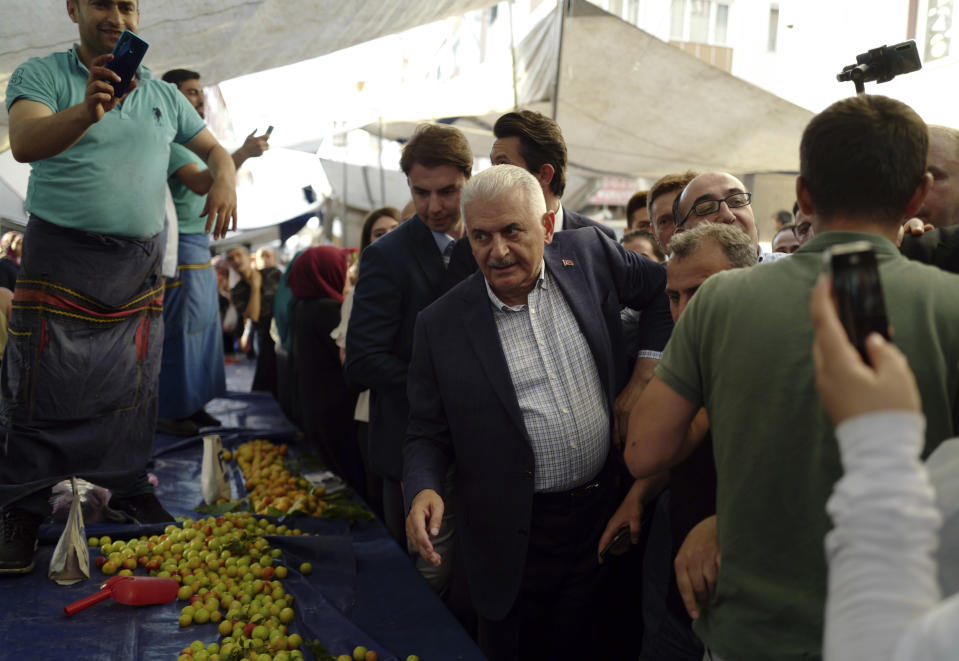 FILE-In this Tuesday, June 11, 2019 file photo, Binali Yildirim, mayoral candidate for Istanbul from Turkey's ruling Justice and Development Party, visits a market, ahead of the June 23 re-run elections, in Istanbul. Millions of voters in Istanbul go back to the polls for a controversial mayoral election re-run Sunday, as President Recep Tayyip Erdogan's party tries to wrest back control of Turkey's largest city. (AP Photo/Burhan Ozbilici, File)