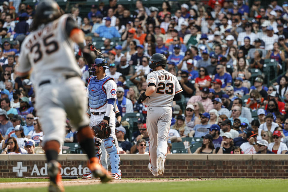 San Francisco Giants' Kris Bryant (23) scores on a two-run single hit by Mike Yastrzemski against the Chicago Cubs during the fifth inning of a baseball game, Saturday, Sept. 11, 2021, in Chicago. (AP Photo/Kamil Krzaczynski)