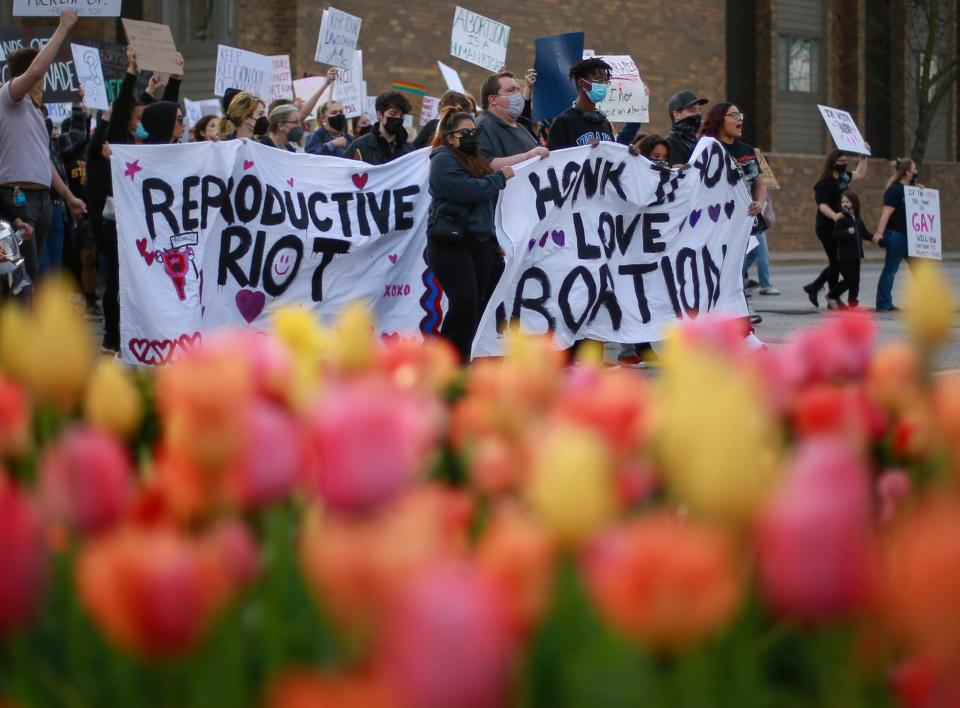 Protesters chant and hold signs in opposition of the United States Supreme Court's document outlining the repeal of Roe v. Wade during the Abort the State rally and march in downtown Des Moines on Wednesday, May 4 2022.