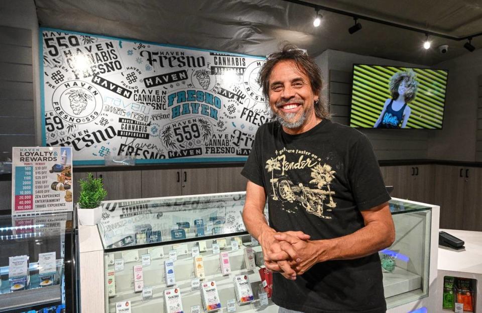 Johnnie Hernandez, president of retail for Haven Cannabis Dispensary, stands in front of the Fresno mural at their new location in downtown Fresno on Tuesday, April 16, 2024.