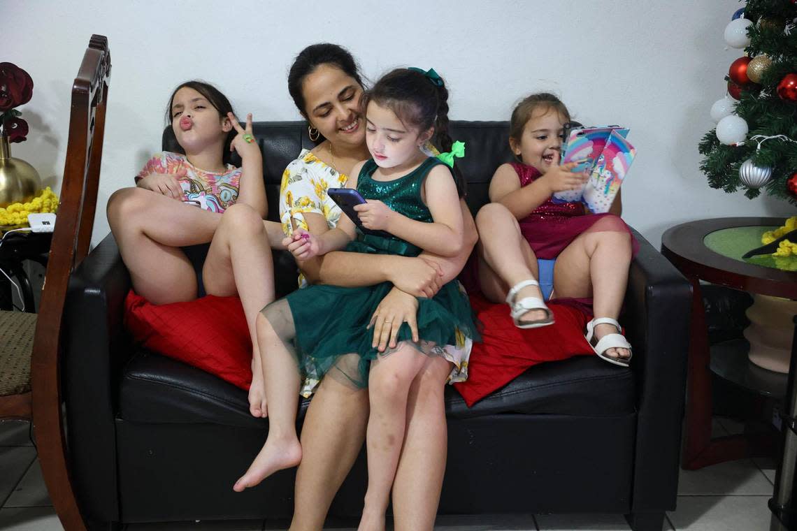 From left tot right: Rachel Leyva, 7, Beatriz Perez, Katherin Leyva, 5, and Evelyn Leyva, 3, sit in their apartment on Thursday, Dec. 1, 2022, in Hialeah. Katherin is diagnosed with Austism Spectrum Disorder. The family lost the majority of their possessions in a fire.