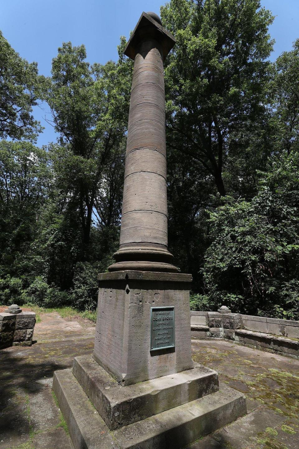 The John Brown Monument is tucked away in a wooded area atop an incline in the Akron Zoo.