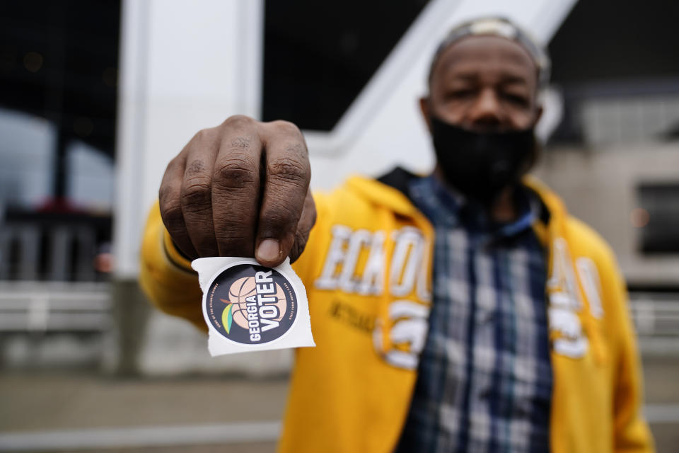 FILE - In this Oct. 28, 2020 file photo, Gary Ragland, 64, votes for the first time at State Farm Arena during early voting in Atlanta. Republicans are moving to make it harder for that to happen again, potentially affecting the voting preferences for millions of Americans in future elections. The GOP's campaign to place new restrictions on mail-in and early voting in certain states will force voters to contend with new rules on what are popular and proven methods of casting ballots. (AP Photo/Brynn Anderson)