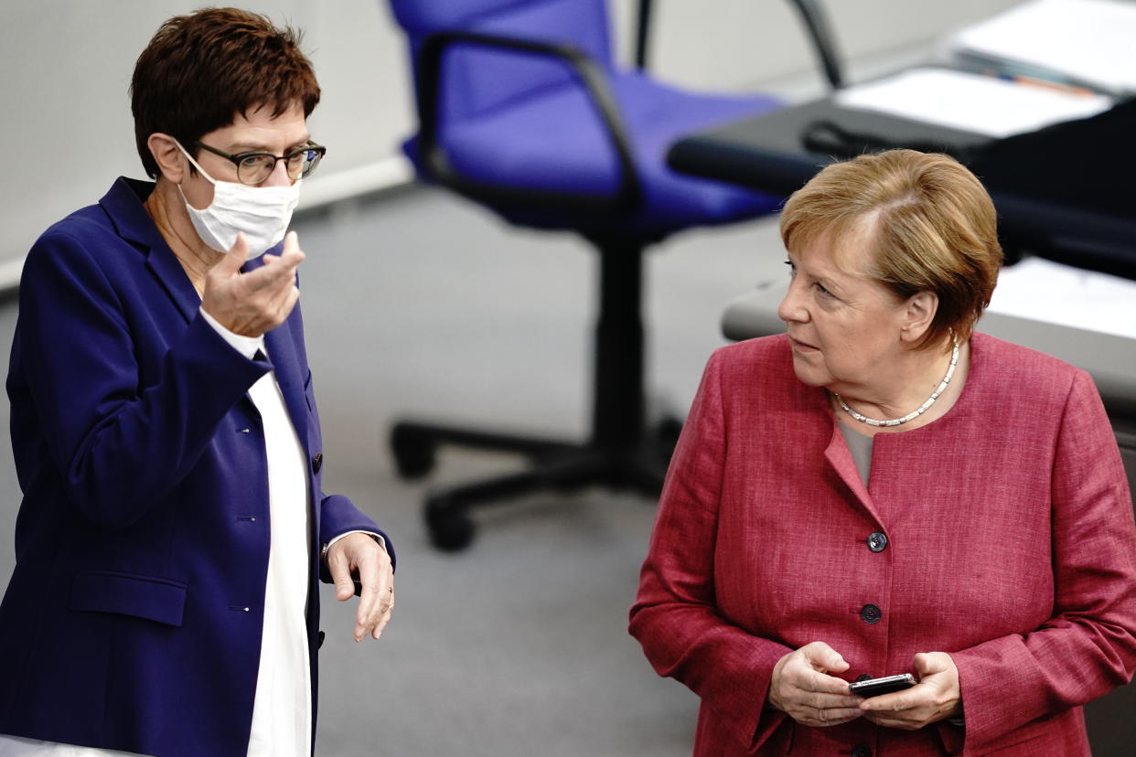 30 September 2020, Berlin: Chancellor Angela Merkel (CDU) talks to CDU Chairwoman and Federal Minister of Defence Annegret Kramp-Karrenbauer (l) during the general debate on the federal budget in the Bundestag. Photo: Kay Nietfeld/dpa (Photo by Kay Nietfeld/picture alliance via Getty Images)