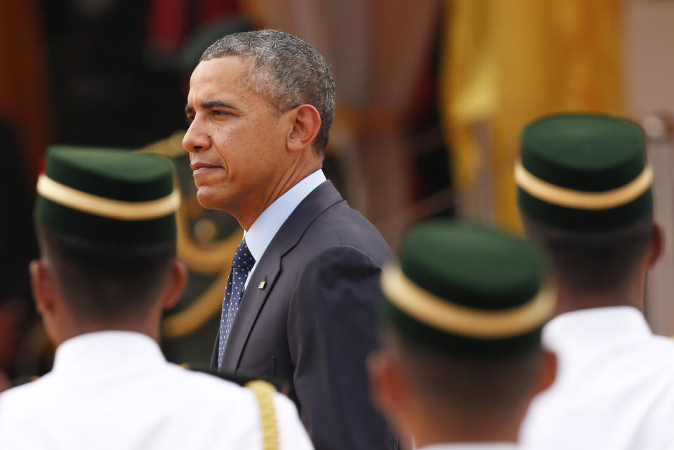 U.S. President Barack Obama, left, walks out from a welcome ceremony at Parliament Square in Kuala Lumpur, Malaysia, Saturday, April 26, 2014. (AP Photo/Vincent Thian)