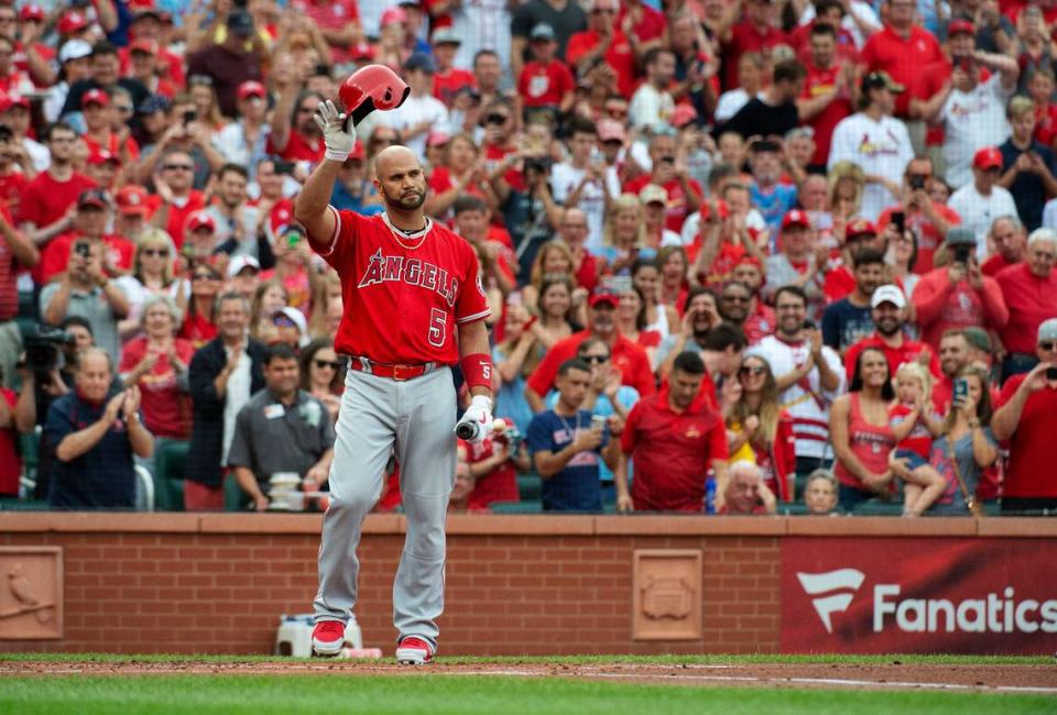 Albert Pujols, then with the Los Angeles Angels, tips his cap during a standing ovation before his first at bat of a game against the St. Louis Cardinals in 2019. Pujols has signed a contract to rejoin the Cardinals organization and arrived in Florida after traveling from southern California on Monday to complete his physical and finalize his contract.
