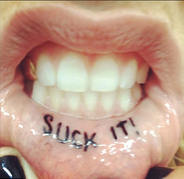 Celebrity photos: Singer Ke$ha got a new tattoo this week – on the inside of her lip. Ouch. The star tweeted an image of the inking which reads ‘Suck it.’ Copyright [Ke$ha]