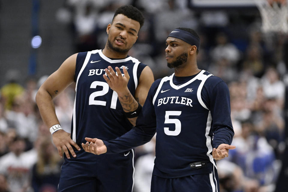 Butler guard Pierre Brooks (21) and Butler guard Posh Alexander (5) talk to each other in the first half of an NCAA college basketball game against UConn, Tuesday, Feb. 6, 2024, in Hartford, Conn. (AP Photo/Jessica Hill)