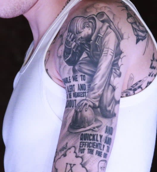 A closeup of the tattoos described