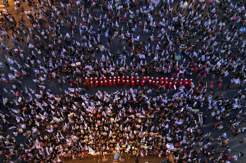 An aerial view shows women dressed as handmaidens from "The Handmaid's Tale" during a demonstration against Israeli Prime Minister Benjamin Netanyahu and his nationalist coalition government's judicial overhaul, in Tel Aviv