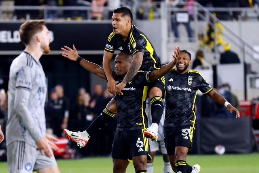 Columbus Crew midfielder Darlington Nagbe (6) celebrates his goal against CF Montreal with teammates forward Cucho Hernandez, top, and defender Steven Moreira (31) during the second half of an MLS soccer match in Columbus, Ohio, Saturday, Oct. 21, 2023. The Crew won 2-1. (AP Photo/Paul Vernon)