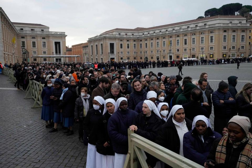 People wait in a line to enter Saint Peter's Basilica at the Vatican (AP)