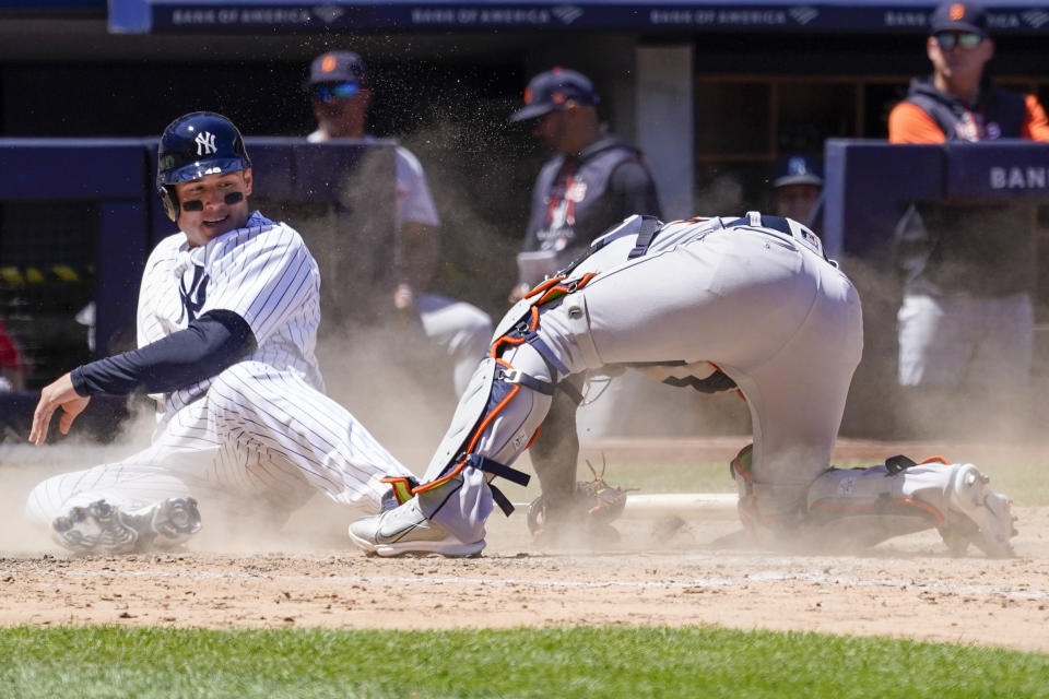 New York Yankees' Anthony Rizzo, left, slides into home base past Detroit Tigers catcher Eric Haase, right, to score off an error to tie a baseball game in the eighth inning Sunday, June 5, 2022, in New York. (AP Photo/Mary Altaffer)