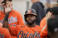 Baltimore Orioles center fielder Cedric Mullins is greeted in the dugout after scoring from second on a single by teammate Ryan Mountcastle during the third inning of a baseball game against the Detroit Tigers, Saturday, July 31, 2021, in Detroit. (AP Photo/Carlos Osorio)