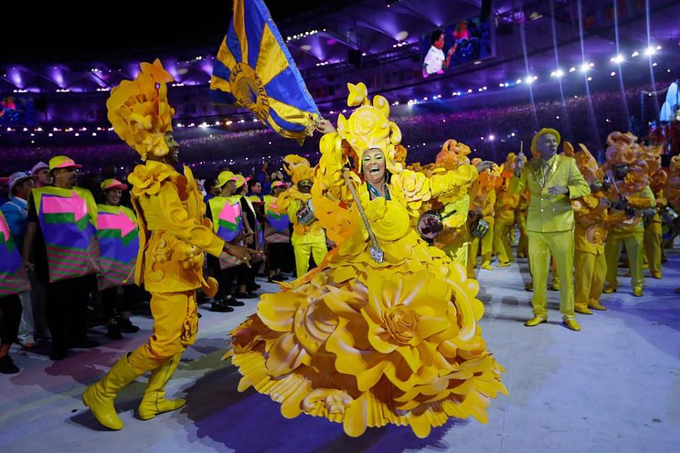 <p>Dancers dressed in bright, colorful costumes performed, as the ceremony featured Brazilian music: samba and funk carioca.</p>