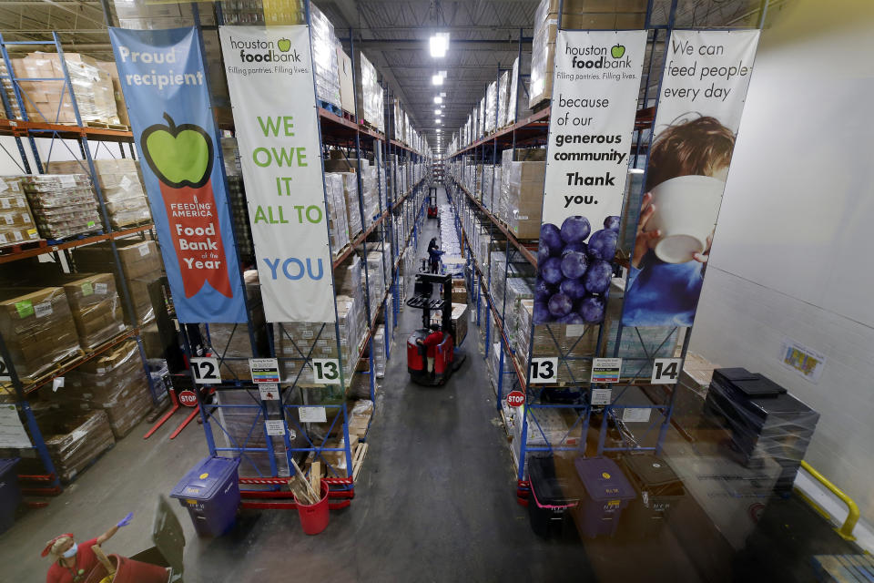 Pallets of various foods are stacked on shelves in the extensive warehouse at the Houston Food Bank Wednesday, Oct. 14, 2020, in Houston. It's the largest U.S. food bank and national food bank leaders say they don't see an end in sight to the demand. (AP Photo/Michael Wyke)