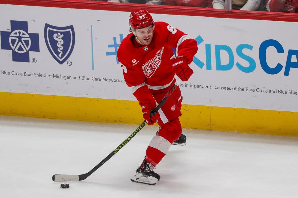 Detroit Red Wings right wing Alex DeBrincat (93) makes a pass against Buffalo Sabres during the third period at Little Caesars Arena in Detroit on Sunday, April 7, 2024.