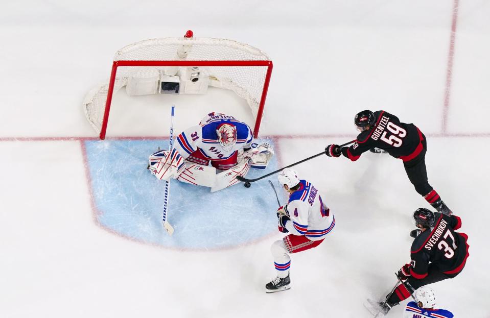 May 11, 2024; Raleigh, North Carolina, USA;New York Rangers goaltender Igor Shesterkin (31) stops a shot attempt by Carolina Hurricanes center Jake Guentzel (59) during the first period in game four of the second round of the 2024 Stanley Cup Playoffs at PNC Arena. Mandatory Credit: James Guillory-USA TODAY Sports