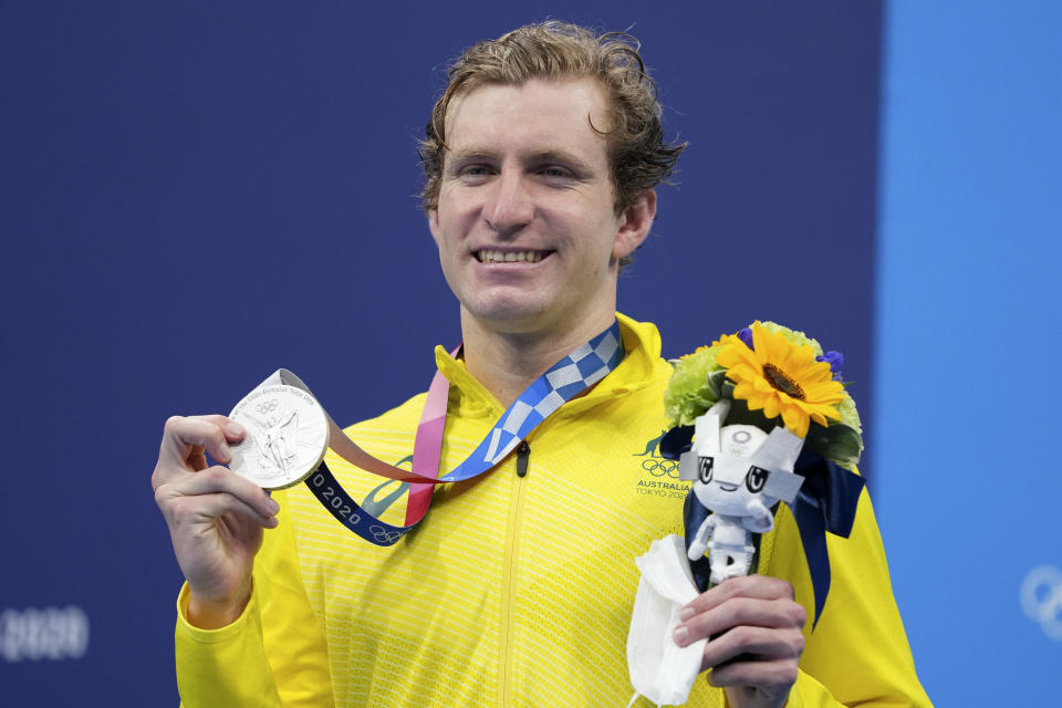 Jack McLoughlin, of the Australia, holds his silver medal on the podium after the final of the men's 400-meter freestyle at the 2020 Summer Olympics, Sunday, July 25, 2021, in Tokyo, Japan. (AP Photo/Matthias Schrader)