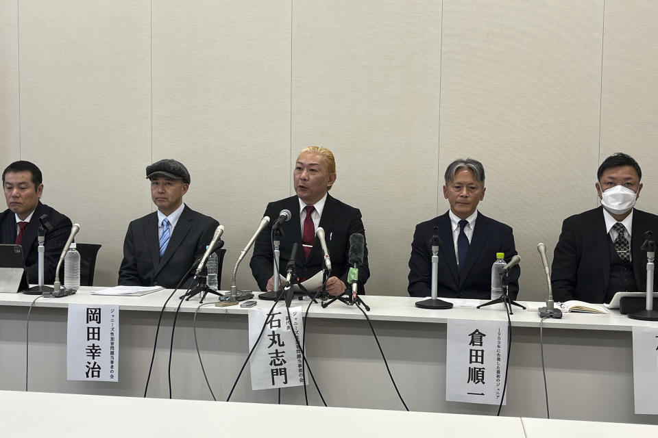 Lawyer Kazuya Sugiyama, right, and Shimon Ishimaru, center, who represents the victims' group, speaks to reporters as he sits with three other victims who came forward alleging they were sexually abused as boys by Japanese entertainment mogul Johnny Kitagawa during a news conference at the government parliamentary buidling in Tokyo, Monday Jan. 15, 2024. Members of a group of men who say they were sexually abused as boys by Kitagawa are accusing the company behind the scandal, previously known as Johnny's, of not being sincere in dealing with the victims. (AP Photo/Yuri Kageyama)