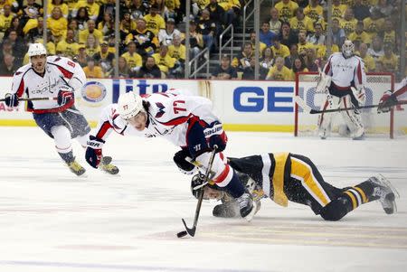 May 4, 2016; Pittsburgh, PA, USA; Washington Capitals right wing T.J. Oshie (77) fights off Pittsburgh Penguins center Oskar Sundqvist (40) as he chases the puck during the third period in game four of the second round of the 2016 Stanley Cup Playoffs at the CONSOL Energy Center. Mandatory Credit: Charles LeClaire-USA TODAY Sports