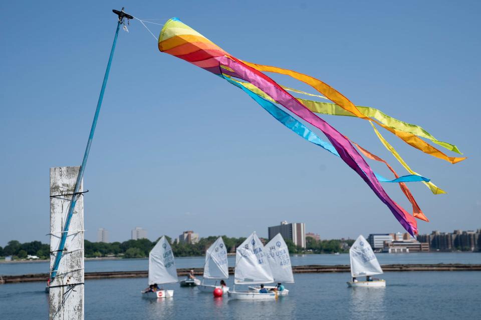 A rainbow windsock indicates wind direction as Detroit Community Sailing Center members teach young students from 10-17 years old how to sail as part of their Challenge the Wind program on Monday, July 24, 2023, from the banks of the Belle Isle Boat House. Challenge the Wind was started by the Detroit Community Sailing Center, which teaches youths ages 10-17 how to sail. The emphasis is on water safety and STEM to help increase access to Detroit's waterways for youths who would otherwise not get the opportunity.