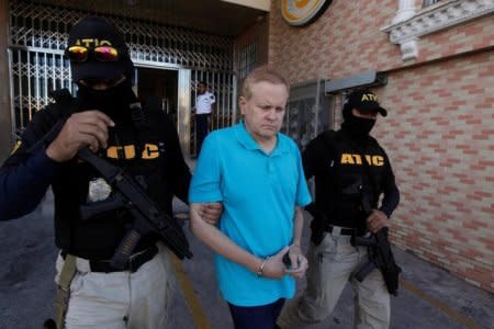 FILE PHOTO: Agents of the Technical Criminal Investigation Agency (ATIC) escort Kentucky attorney Eric Christopher Conn, 57, wanted by the FBI over his role in a disability fraud scheme, in Tegucigalpa, Honduras December 5, 2017. REUTERS/Jorge Cabrera