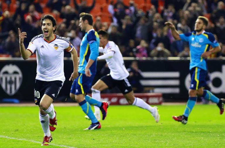 Valencia's midfielder Dani Parejo (L) celebrates his goal during the Spanish league football match Valencia vs Sevilla at Mestalla stadium in Valencia on January 25, 2015