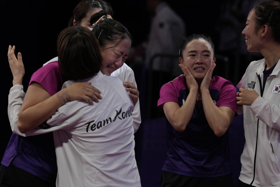 South Korea's Jeon Jihee, second from right and Shin Yubin, second from left cries as they celebrating defeating North Korea to win the Table Tennis Women's Doubles Final match for the 19th Asian Games in Hangzhou, Monday, Oct. 2, 2023. (AP Photo/Ng Han Guan)