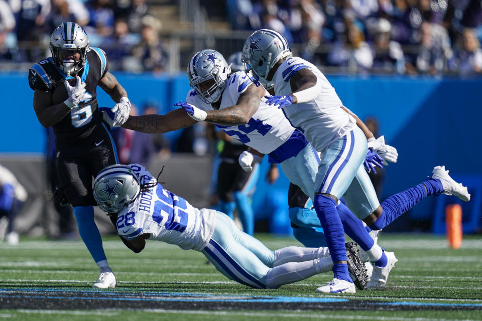 Carolina Panthers running back Miles Sanders is tackled by Dallas Cowboys safety Malik Hooker during the first half of an NFL football game Sunday, Nov. 19, 2023, in Charlotte, N.C. (AP Photo/Erik Verduzco)