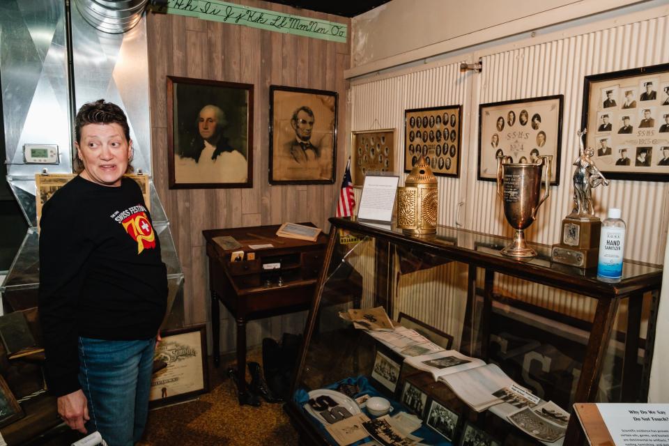 Becky Detwiler, curator of the Alpine Museum in Sugarcreek, talks about the necessity for installation of an elevator, which will be located behind the current shaft doors pictured at right, Friday, Dec. 22.