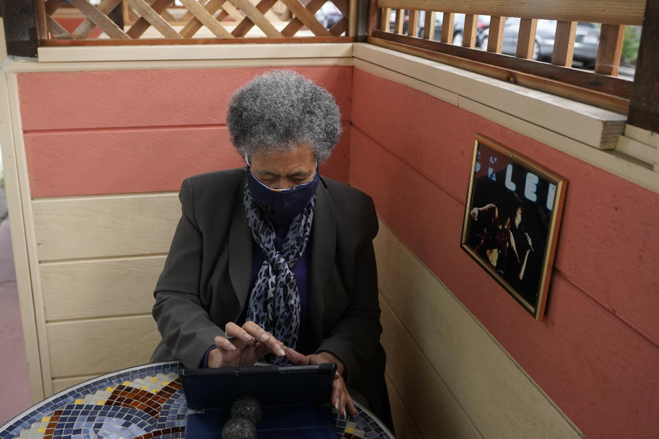 Lynnette White uses her tablet in San Francisco, Tuesday, Feb. 16, 2021. The pandemic has sparked a surge of online shopping across all ages as people stay away from physical stores. But the biggest growth has come from consumers 65 and older. (AP Photo/Jeff Chiu)