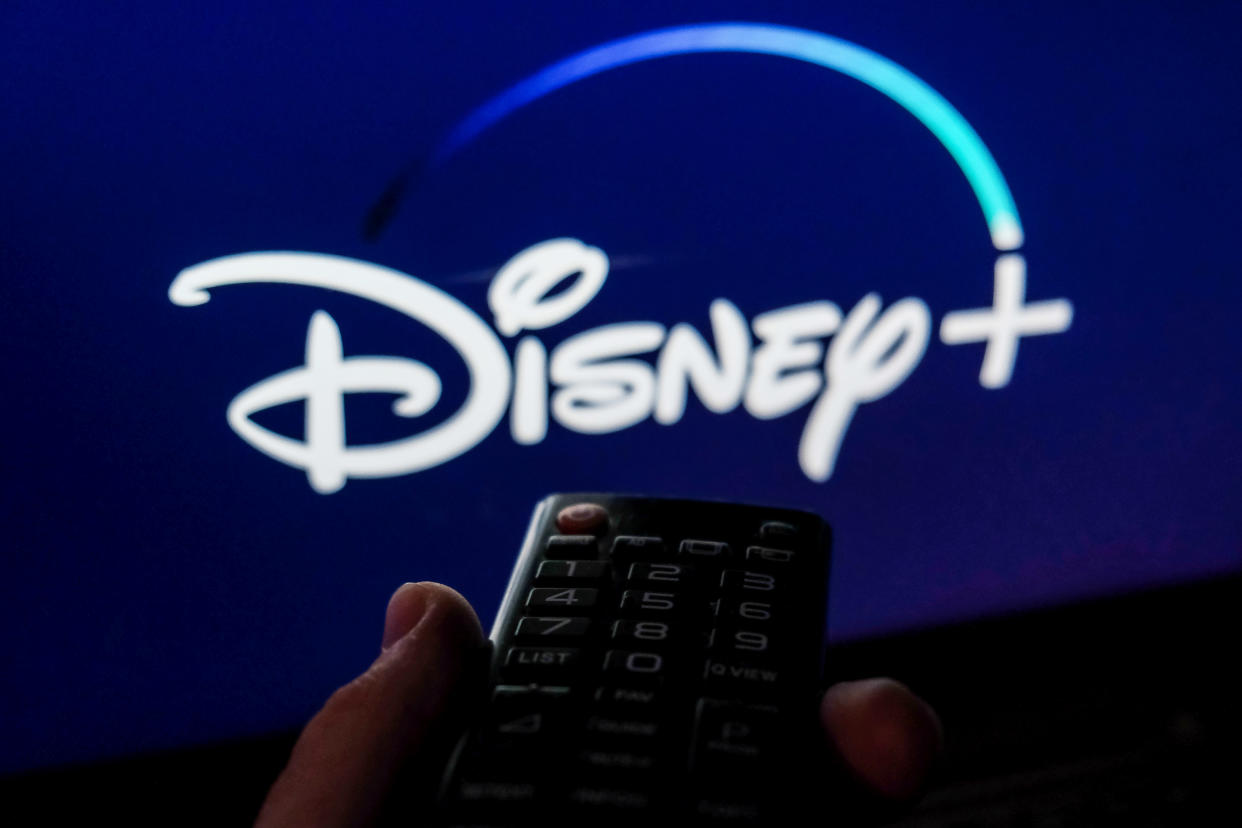 TV remote control is seen with Disney+ logo displayed on a screen in this illustration photo taken in Krakow, Poland on February 6, 2022. (Photo by Jakub Porzycki/NurPhoto via Getty Images)