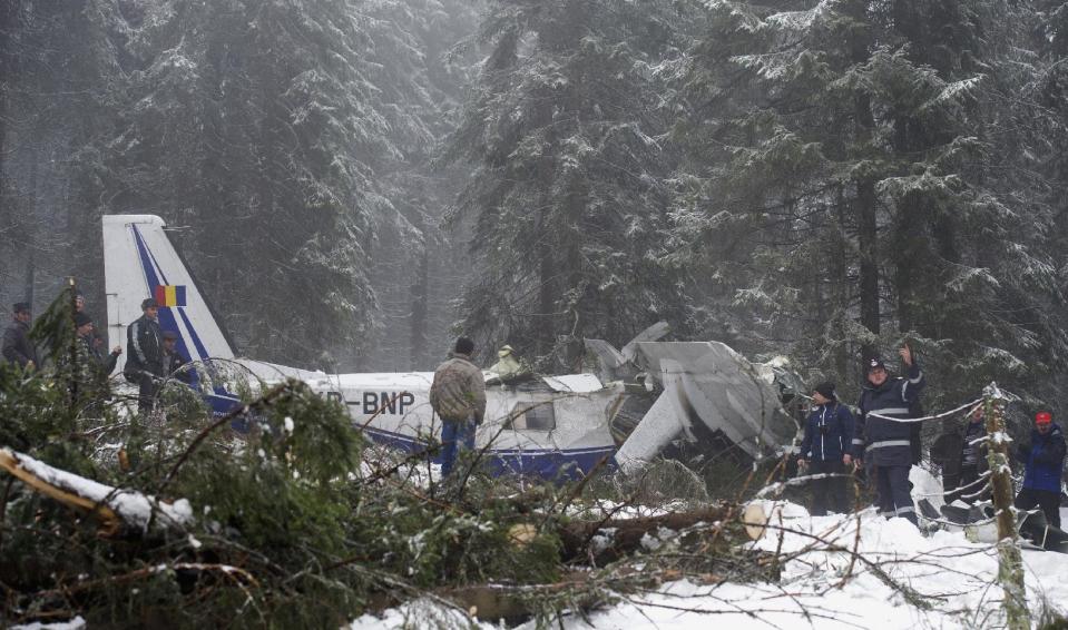 In this Wednesday, Jan. 22, 2014 photo, the wreckage of a small plane is seen near the Petreasa peak in western Romania. The small plane, carrying a pilot and six medical workers to harvest organs for transplant, crashed on a mountain Monday, Jan. 20, 2014. Residents located the plane four and a half hours after it crashed, but medical teams arrived much later, provoking public anger. The pilot and a medical student died from hypothermia and multiple injuries.(AP Photo/Catalin Cadan/Mediafax Foto) ROMANIA OUT