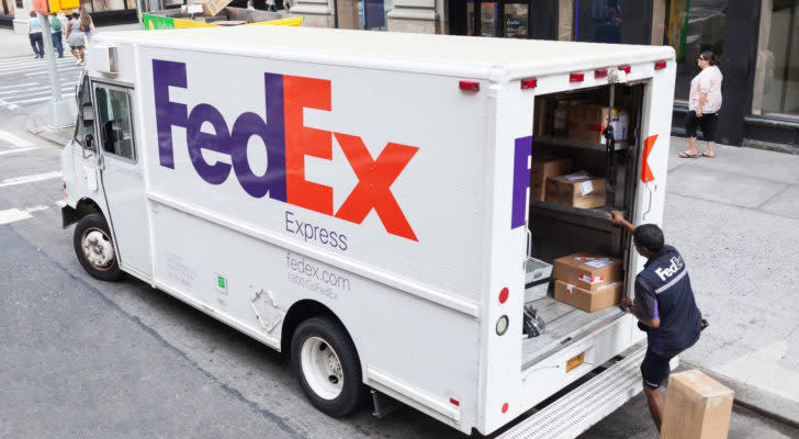 A FedEx (FDX) employee loads a FedEx Express truck in Manhattan.