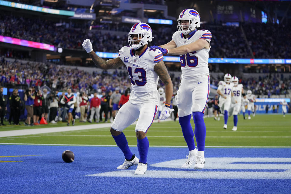 Buffalo Bills wide receiver Gabe Davis (13) celebrates his touchdown reception with tight end Dalton Kincaid (86) during the first half of an NFL football game against the Los Angeles Chargers, Saturday, Dec. 23, 2023, in Inglewood, Calif. (AP Photo/Ashley Landis)