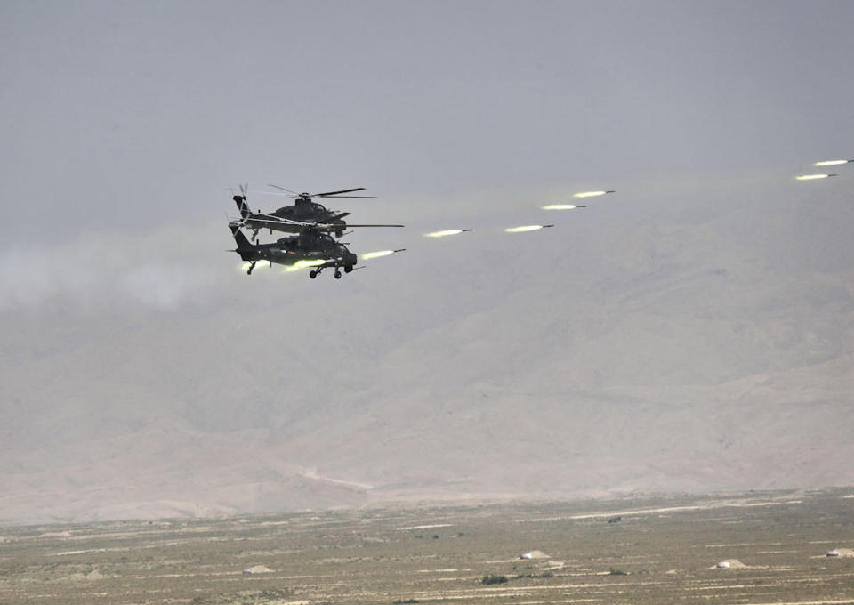 FILE - In this handout photo released by Russian Defense Ministry Press Service, Chinese military helicopter gunships fire rockets during joint war games held by Russia and China held in the Ningxia Hui Autonomous Region in northwestern China on Friday, Aug. 13, 2021. Russia said Monday it will launch sweeping war games drills in the country's east that will involve forces from China — a show of increasingly close military ties between Moscow and Beijing amid tensions with the West over the Kremlin's action in Ukraine. (Savitskiy Vadim/Russian Defense Ministry Press Service via AP, File)