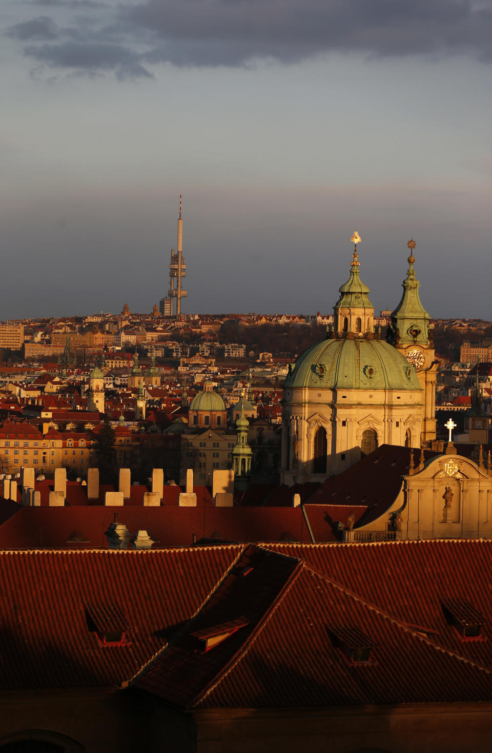 In this picture taken March 6, 2013, Zizkov television tower peaks over the skyline of Prague, Czech Republic. Following its completion in 1992, the 216-meter (236-yard) tall television tower in the Czech capital has become a dominant landmark of the city skyline that offers a breathtaking view of Prague from its restaurant and observation desk. (AP Photo/Petr David Josek)