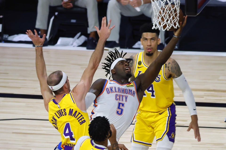 LAKE BUENA VISTA, FLORIDA - AUGUST 05:  Luguentz Dort #5 of the Oklahoma City Thunder attempts a shot against Alex Caruso #4 of the Los Angeles Lakers during the second quarter at HP Field House at ESPN Wide World Of Sports Complex on August 05, 2020 in Lake Buena Vista, Florida. NOTE TO USER: User expressly acknowledges and agrees that, by downloading and or using this photograph, User is consenting to the terms and conditions of the Getty Images License Agreement. (Photo by Kevin C. Cox/Getty Images)