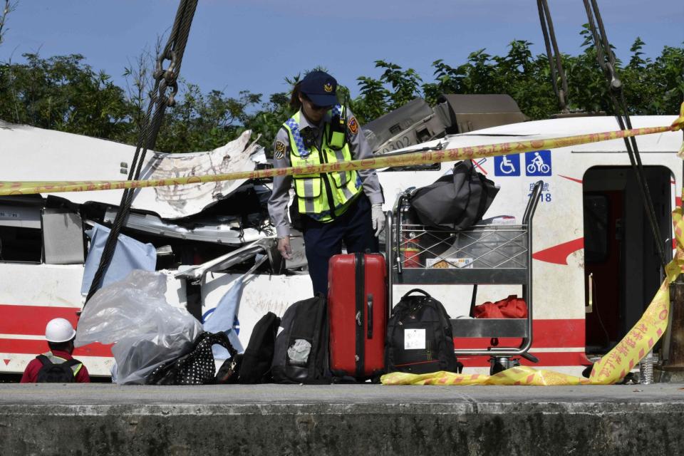 A police officer inspects luggage from the train (AFP/Getty Images)