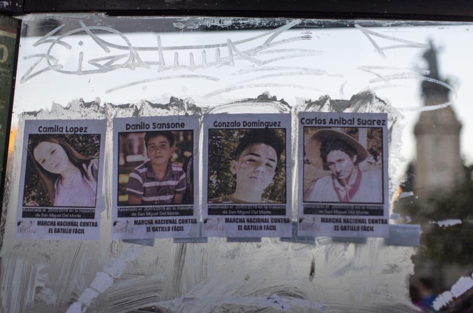 Posters of the four victims of Monday's police shooting, from left, Camila Lopez, Danilo Sansone, Gonzalo Dominguez and Carlos Anibal Suarez are glued to a bus stop, in Buenos Aires, Argentina, Friday, May. 24, 2019. Argentines protested after officers on Monday fired shots that led to the deaths of the three teenagers and a young man in a car chase. (AP Photo/Tomas F. Cuesta)