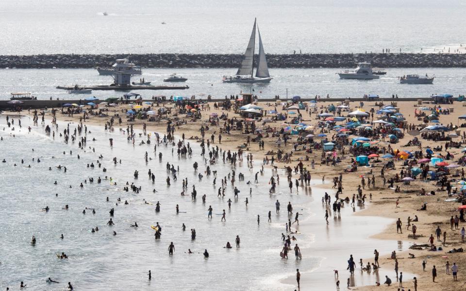 Beach goers in Southern Californian - Shutterstock 