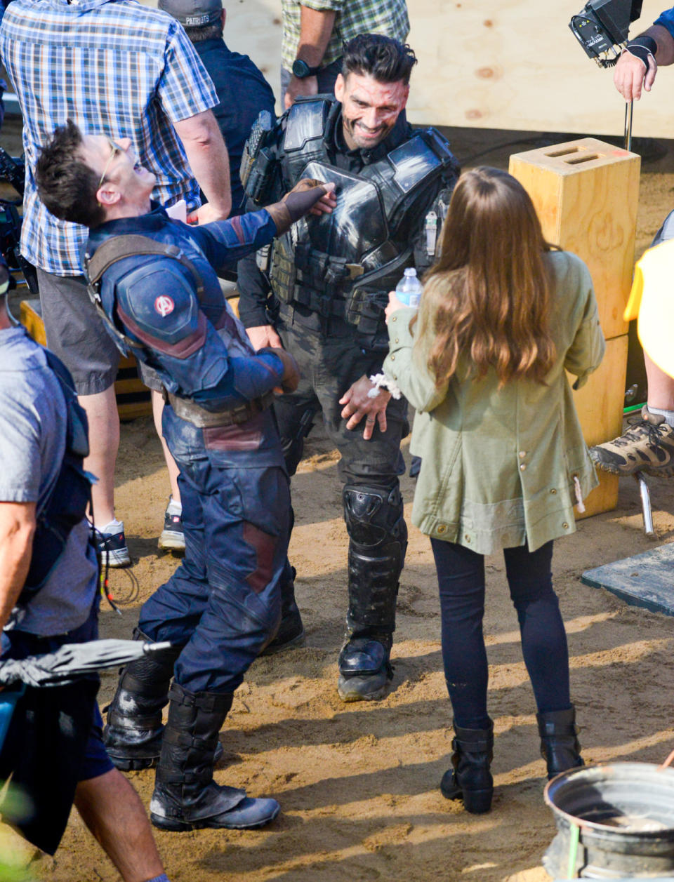 Avengers teammates Captain America (Chris Evans) and Scarlet Witch (Elizabeth Olsen) share a laugh with their mortal enemy Crossbones (Frank Grillo) in between takes on set.