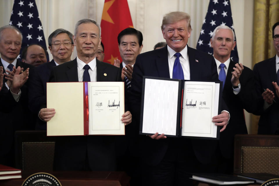 FILE - In this Wednesday, Jan. 15, 2020, file photo, U.S. President Donald Trump, right, signs a trade agreement with Chinese Vice Premier Liu He, in the East Room of the White House, in Washington. China’s government welcomed an interim trade deal with Washington and said Thursday the two sides need to address each other’s “core concerns.” (AP Photo/Evan Vucci, File)
