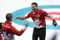 <p>Canada’s John Morris celebrates winning the curling mixed doubles gold medal. </p>