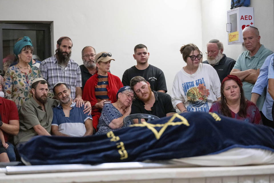 Mourners attend the funeral of Batsheva Nigri, at a cemetery in the West Bank Jewish settlement of Kfar Etzion, Monday, Aug. 21, 2023. Israeli authorities say that a suspected Palestinian attacker has killed an Israeli woman and seriously wounded a man in the incident. (AP Photo/Ohad Zwigenberg)