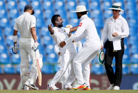 Cricket - Sri Lanka v India - Third Test Match - Pallekele, Sri Lanka - August 12, 2017 - Sri Lanka's Malinda Pushpakumara celebrates with captain Dinesh Chandimal after taking the wicket of India's Ajinkya Rahane. REUTERS/Dinuka Liyanawatte